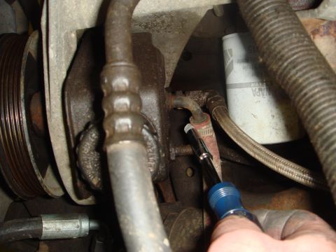 1996 Ford Bronco - A mechanic works on a power steering pump, with a NAPA oil filter visible in the background.