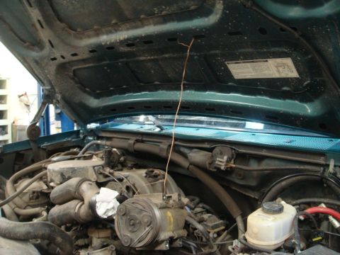 1996 Ford Bronco - Engine bay of a 1996 Ford Bronco with the hood raised, revealing the engine and associated parts.