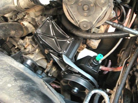 1996 Ford Bronco - A newly installed power steering pump assembly with hoses and a pulley is visible in the engine compartment.