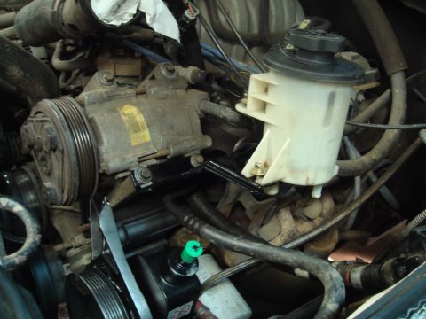 1996 Ford Bronco - Close-up view of engine components including the power steering pump and AC compressor.