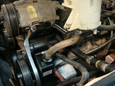 1996 Ford Bronco - Close-up view of the power steering pump and associated components within an engine bay.