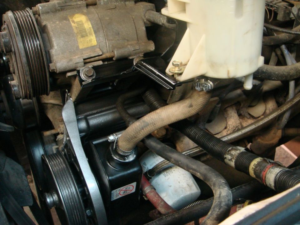 Power steering pump and pulley system in engine bay