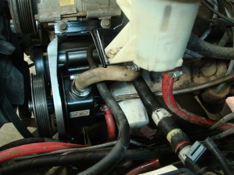 1996 Ford Bronco - Close-up view of a vehicle's power steering pump and reservoir assembly.