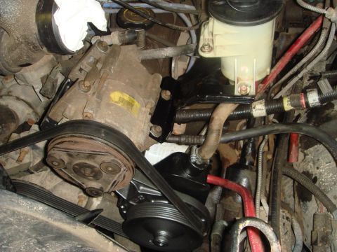 1996 Ford Bronco - Close-up view of engine components including the power steering pump and AC compressor.