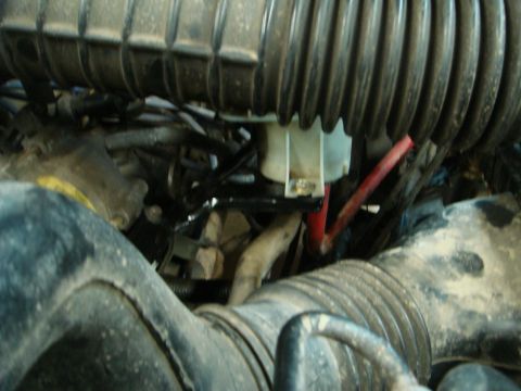 1996 Ford Bronco - This image shows various engine components, including hoses and electrical wiring, within a vehicle's engine compartment.