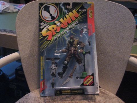 1991 Ford Bronco - This Spawn action figure, named Clutch, is displayed in its original packaging with various accessories.