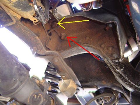 1986 Ford Bronco - Underside view of vehicle frame and suspension parts, with directional arrows indicating specific areas.