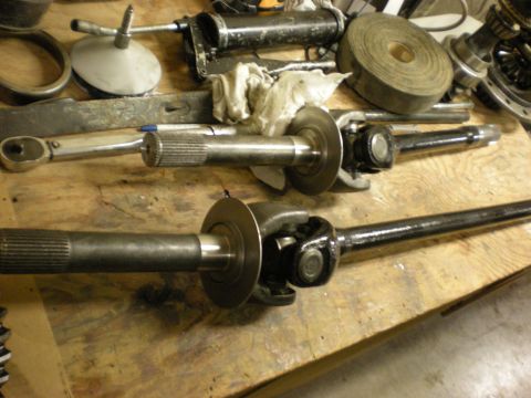 1993 Ford Bronco - Drive shafts and automotive tools laid out on a workbench.
