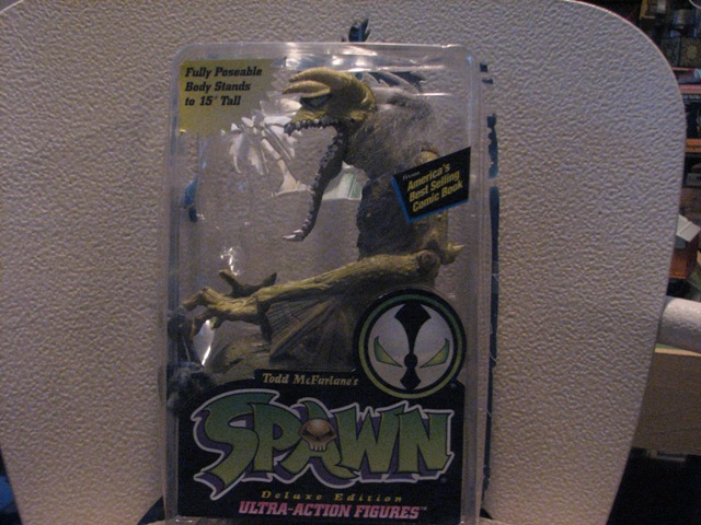 Spawn action figure in plastic packaging with text 'Fully Poseable Body Stands to 15" Tall'