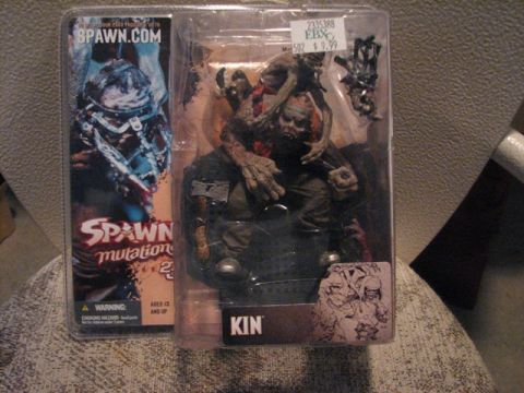 1991 Ford Bronco - A close-up of two Spawn action figures in their original packaging, one labeled 'KIN'.