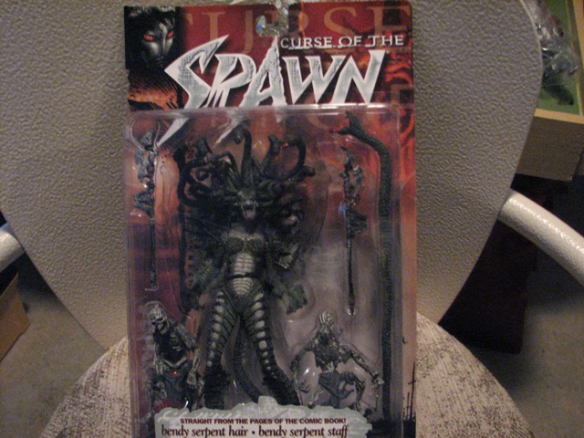 Curse of the Spawn action figure in packaging. Figure has snake hair and is green