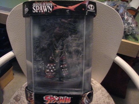 1991 Ford Bronco - Action figure packaging for "Arsenal of Doom Spawn" is displayed on a chair.