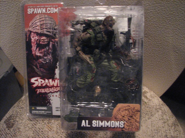 Spawn action figure, Al Simmons, in plastic packaging with "Spawn.com" and "Spawn mutation" text