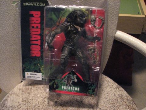 1991 Ford Bronco - A collectible Predator action figure is displayed in its clear plastic packaging.