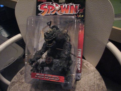 1991 Ford Bronco - The Heap action figure from Spawn, with text indicating its mouth opens to spew garbage.