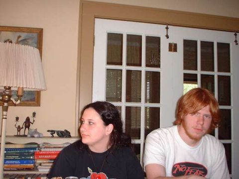 1996 Ford Taurus - Two people are sitting in a room with a lamp and bookshelves in the background.