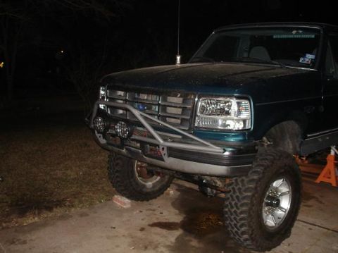 1996 Ford F-150 - Front 3/4 view of a green Ford F-Series truck with a custom bumper and off-road lights.