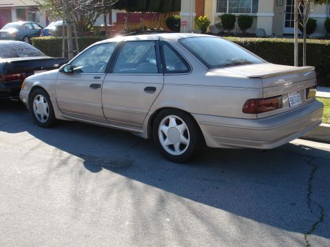 1991 Ford Taurus - Rear view of a 1991 Ford Taurus sedan parked on a residential street.