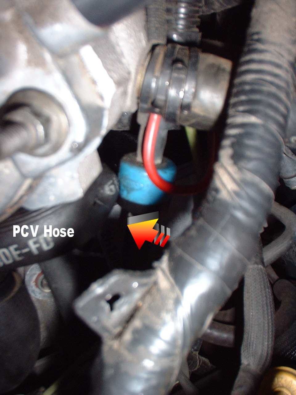 PCV hose with red wire and blue connector, engine bay detail