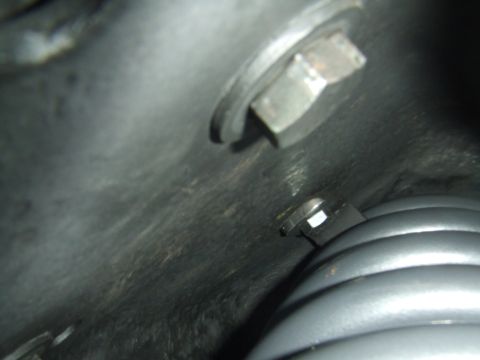 1996 Ford Bronco - A close-up view of a vehicle's suspension component, with visible bolts and a spring, and the Supermotors logo.