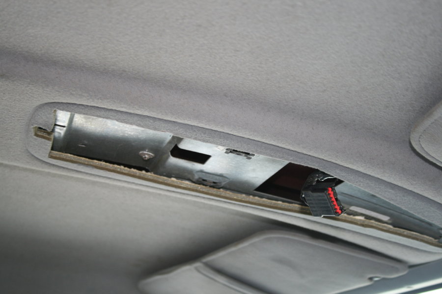 Overhead console interior with exposed wiring and mounting bracket. 1996 Ford Bronco