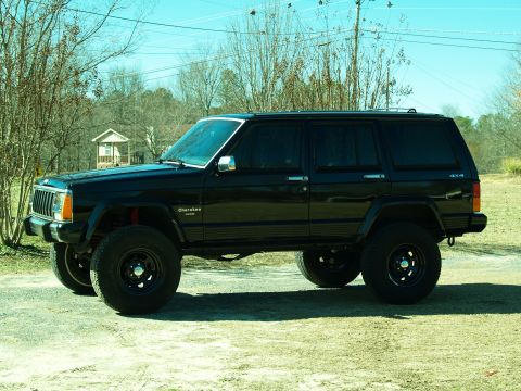 1989 Jeep Cherokee - This black Jeep Cherokee has a lifted suspension and aftermarket wheels.