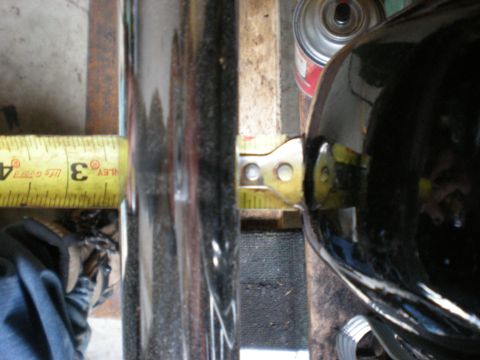 1993 Ford Bronco - Measuring a component with a yellow tape measure in a workshop setting.