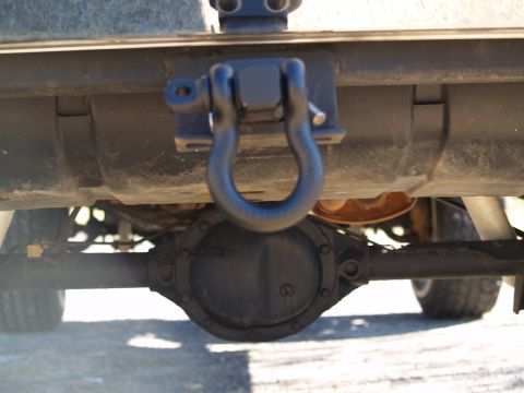 1989 Jeep Cherokee - Close-up view of a vehicle's rear differential and a heavy-duty tow hitch shackle.