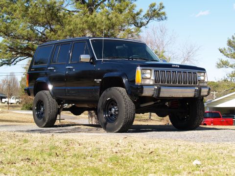 1989 Jeep Cherokee - This black 1989 Jeep Cherokee features a lifted suspension and large off-road tires.