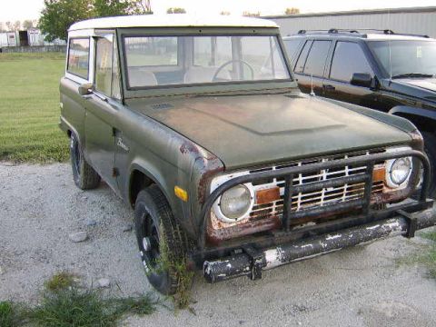 1986 Ford Ranger - A vintage Ford Bronco sits parked on a gravel lot next to a modern SUV.