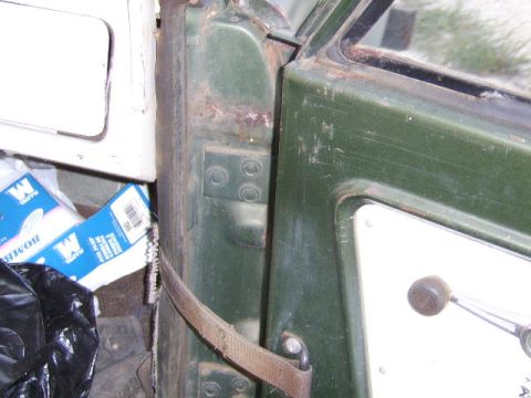 1986 Ford Ranger - Interior view of a green vehicle door, showing signs of wear and rust around the hinges and frame.