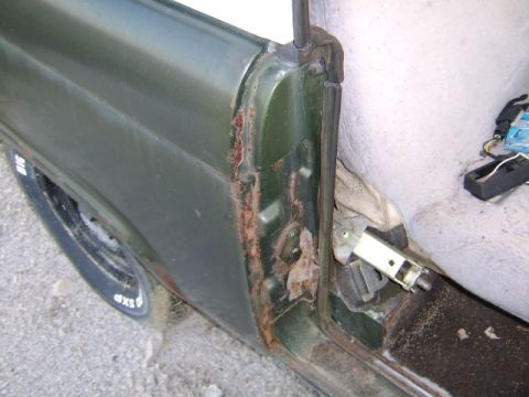 1986 Ford Ranger - Close-up of a 1986 Ford Ranger's rusted door jamb and interior components.