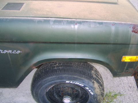 1986 Ford Ranger - Close-up of a 1986 Ford Bronco's side fender and wheel, showing some rust.