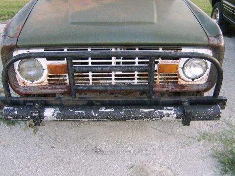 1986 Ford Ranger - This vintage Ford Bronco shows significant wear and tear, with rust visible on the grille and hood.