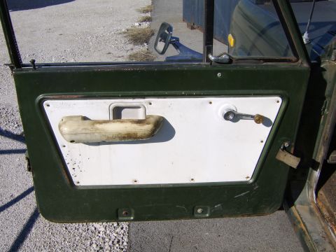 1986 Ford Ranger - Interior view of a vehicle's door panel, showing the armrest, window crank, and door handle mechanism.