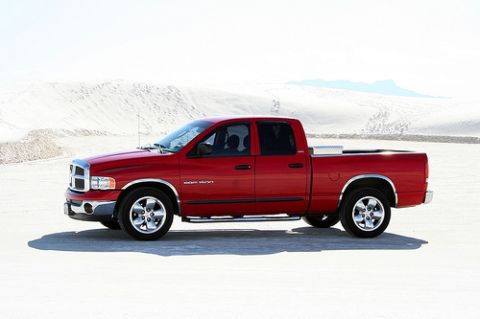 1991 Ford Crown Victoria - A red Dodge Ram pickup truck is seen from the side in a desert landscape.