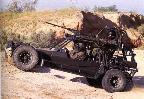 1991 Ford Crown Victoria - This military buggy, equipped with a heavy machine gun and two crew members, navigates a desert landscape.