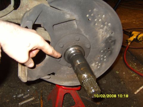 1989 Ford Bronco - Vehicle spindle and brake rotor assembly being worked on, with a hand pointing. Date stamp visible: 10/02/2008.