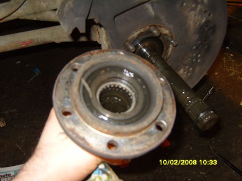 1989 Ford Bronco - Close-up of a disassembled spindle bearing assembly, showing internal splines and wear.