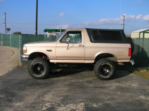 1996 Ford Bronco - This lifted Ford Bronco features a removable soft top, giving it a distinct profile.