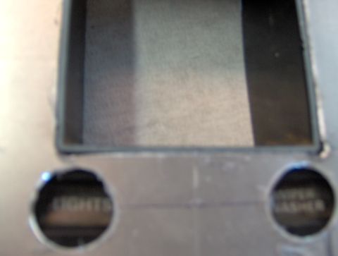 1978 Ford Bronco - Close-up of a dashboard section showing cutouts for controls labeled 'LIGHTS' and 'WASHER'.