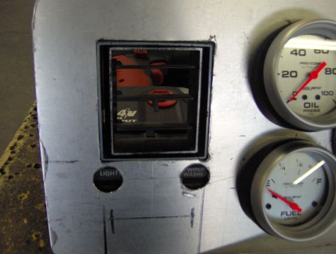 1978 Ford Bronco - A close-up of a custom-made dashboard panel various gauges and controls.