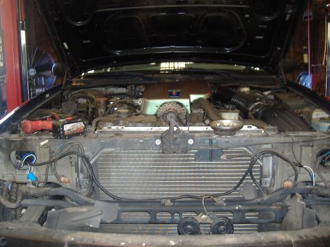 2001 Ford Crown Victoria - Front end repairs on a 2001 Ford Crown Victoria, with the hood open to access the engine.