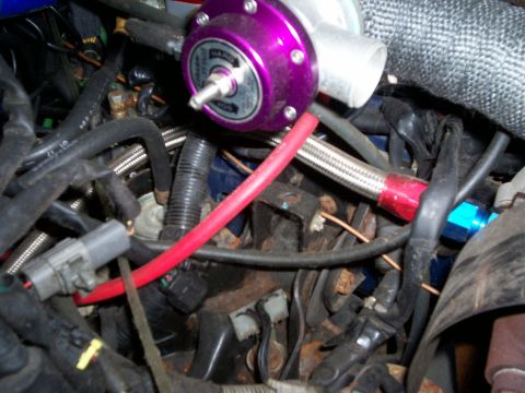 1994 Ford Probe - Close-up of engine bay components, including a blow-off valve and braided hoses.
