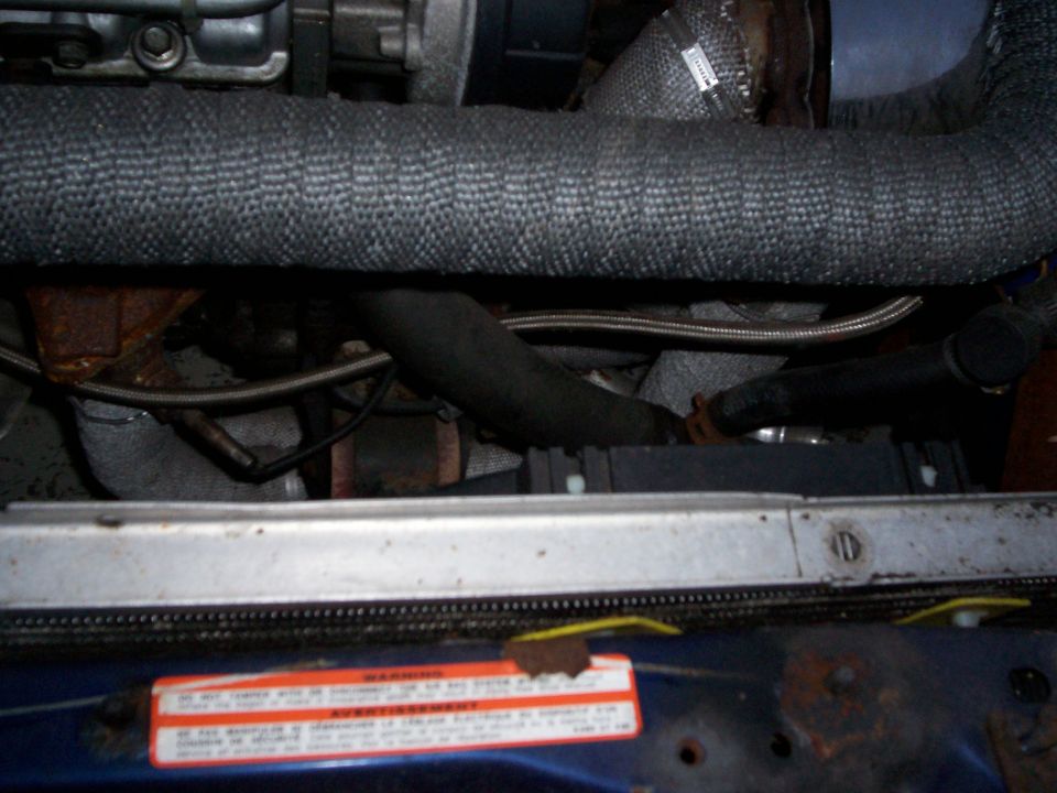 Engine bay with turbocharger pipes and heat wrap