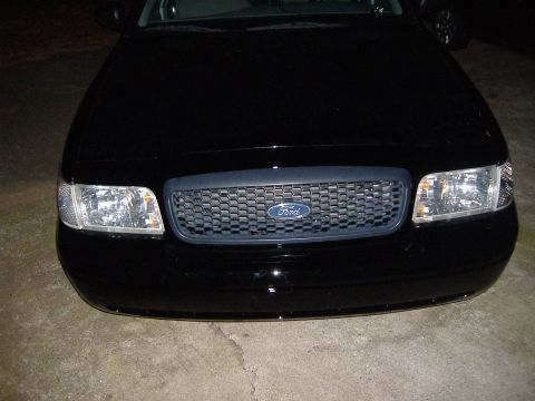 2001 Ford Crown Victoria - Front view of a black 2001 Ford Crown Victoria showing the grille and headlights.