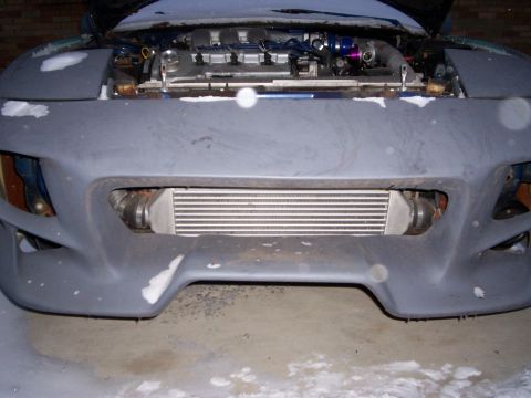1994 Ford Probe - Front view of a car with its hood up, revealing the engine and an intercooler installed.