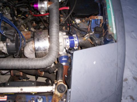 1994 Ford Probe - Close-up view of a modified engine bay, showing a turbocharger and associated plumbing. The vehicle's year is not discernible.