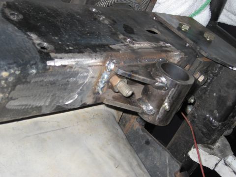 1994 Ford Bronco - This image shows a close-up view of welded metal components and bolts on a vehicle's frame, likely part of a repair or modification.