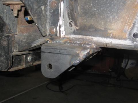 1994 Ford Bronco - Close-up of a modified vehicle frame showing new welding and a bracket with a hole.